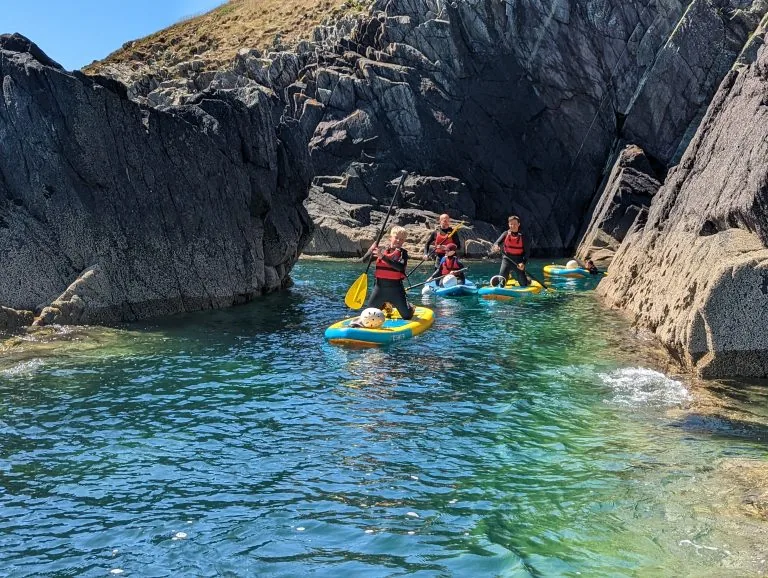 Paddleboarding between coastal rocks in Pembrokeshire
